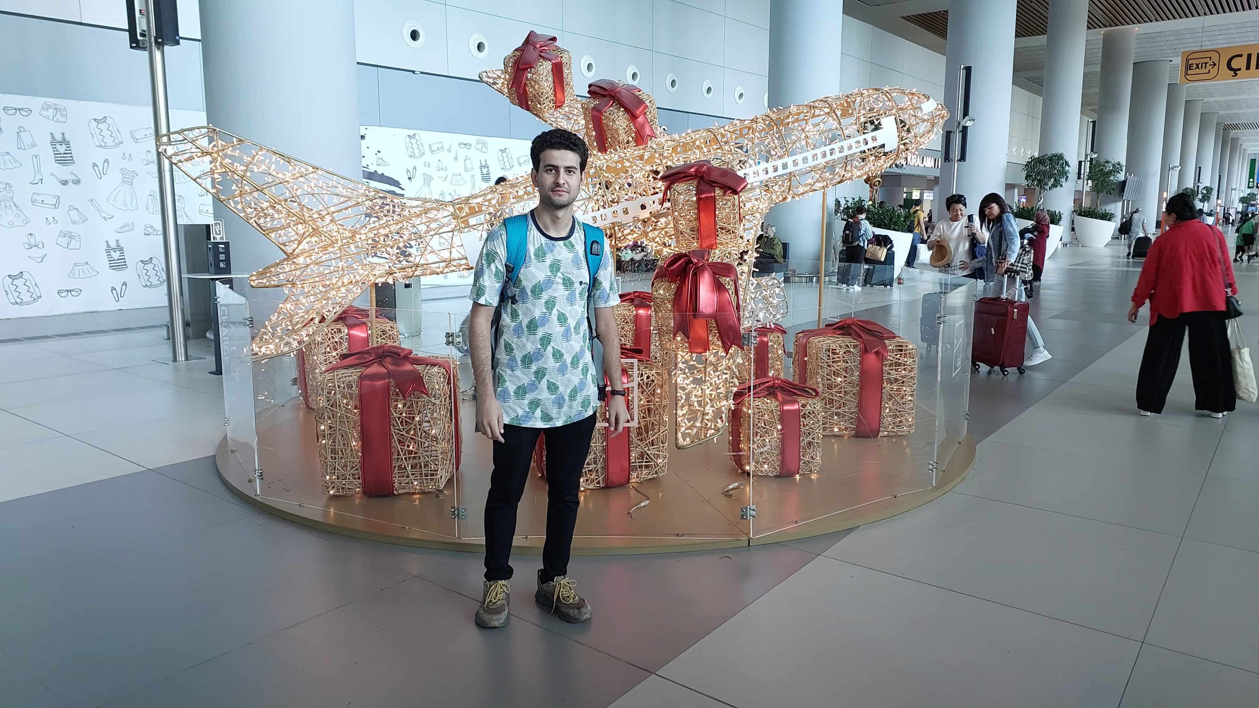 Sina Kazemi next to the plane statue in Istanbul airport